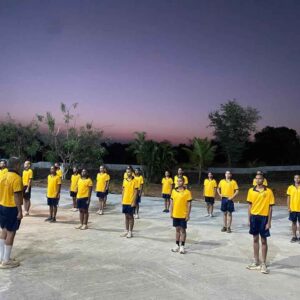 Group of students in yellow uniforms.