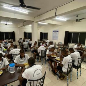 Group of students eating in cafeteria.